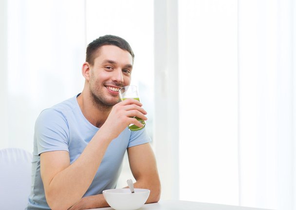 happy man having breakfast at home - Фото, изображение