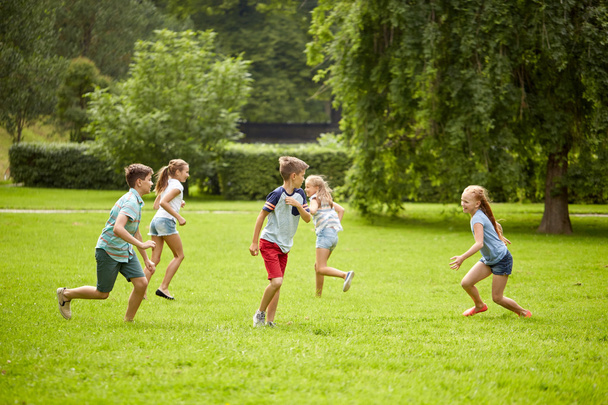 happy kids running and playing game outdoors - Fotoğraf, Görsel