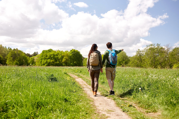 happy couple with backpacks hiking outdoors - Foto, imagen
