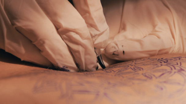 Tattoo master making a tattoo of mandala pattern. Close up shot of hands - Imágenes, Vídeo