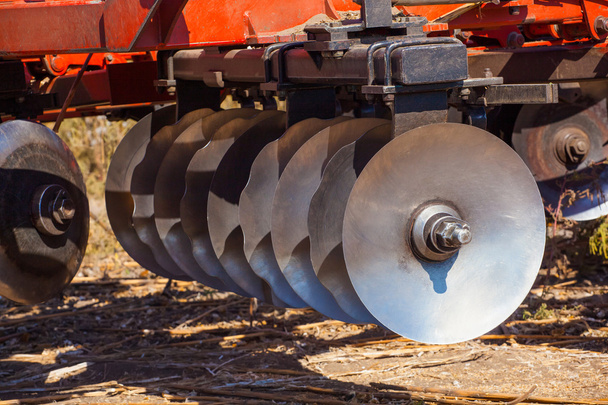 Part of the cultivator, steel, round discs in a row. Close-up. The work of agricultural machinery. - Photo, Image