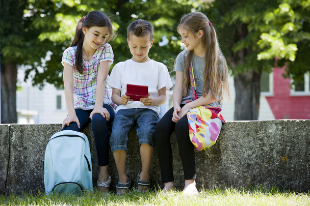 Children playing video games outdoors - Photo, Image