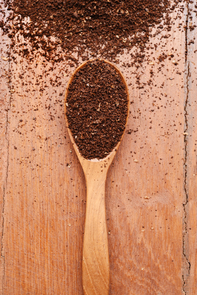 Ground coffee in wooden spoon  - Fotó, kép