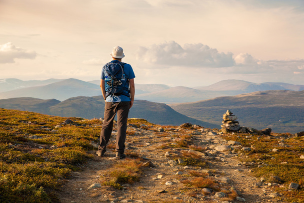 hiker with backpack traveling in Norway mountains Dovre - Photo, Image