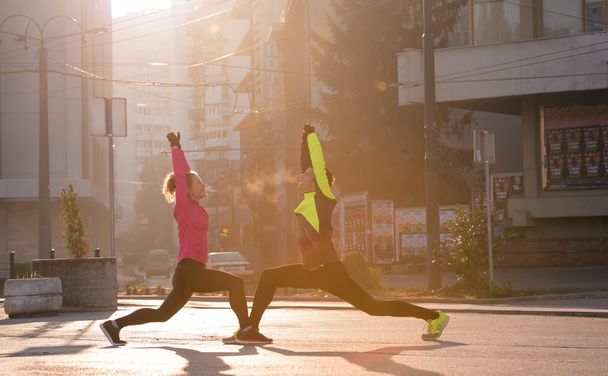 couple warming up before jogging - 写真・画像
