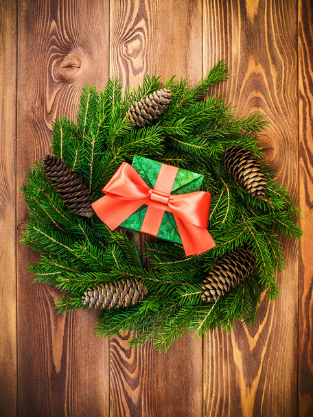 Wreath on the wooden board. Wrapped gift box. Christmas and New year concept - Foto, Imagen