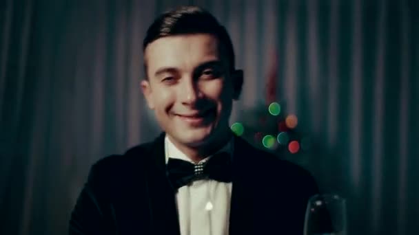 a Young Man With a Glass of Champagne and Sparklers Joyfully Exclaims Greeting. - Filmagem, Vídeo