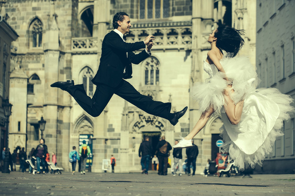 wedding happy couple jumping near castle - Fotoğraf, Görsel