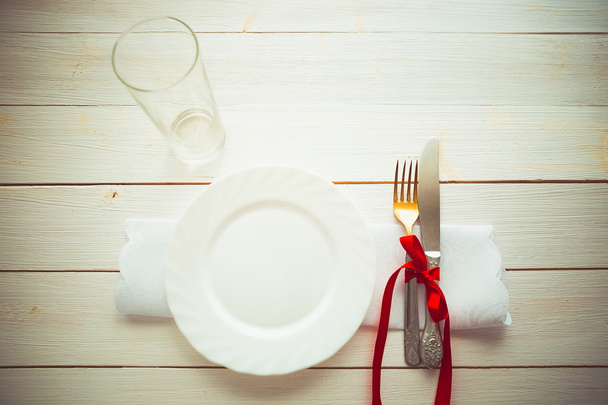 Knife, fork and dish over wooden table - Fotografie, Obrázek