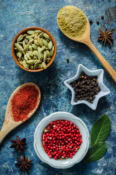 Spices on blue stone background with space for text. - Foto, afbeelding