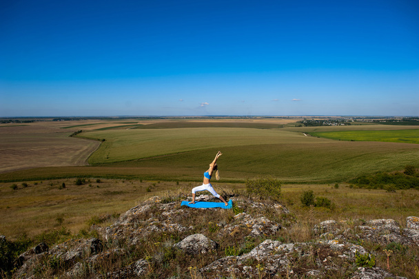 Young woman doing yoga - 写真・画像