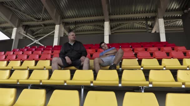 Sports fan awakened friend in stadium - Footage, Video