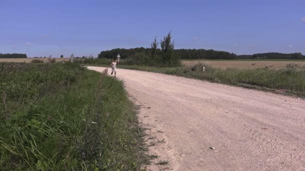Young athlete running away on rural road - Footage, Video