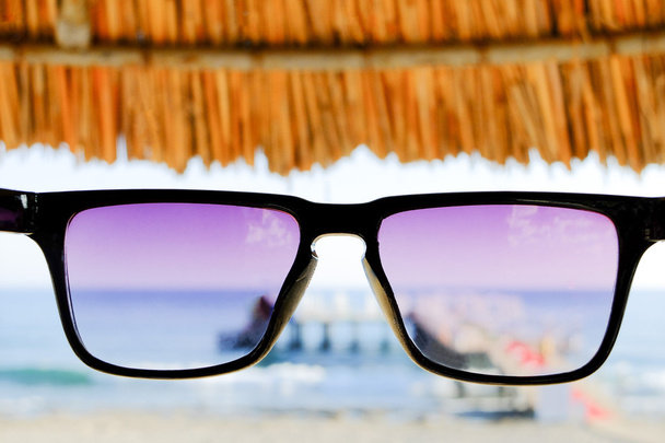 Sunglasses at sea background - 写真・画像