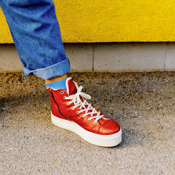 Stylish red sneakers. Urban fashion Autumn comes - 写真・画像