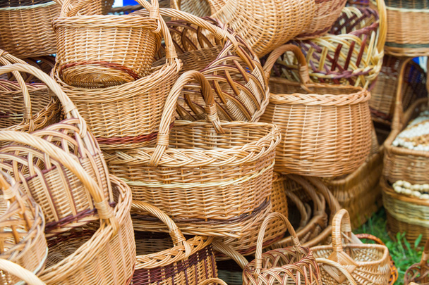 baskets woven from willow twigs. a container used to hold or carry things, typically made from interwoven strips of cane or wire. - Fotó, kép