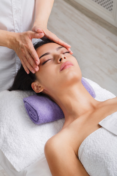 Woman beautician doctor make head massage in spa wellness center - Fotografie, Obrázek