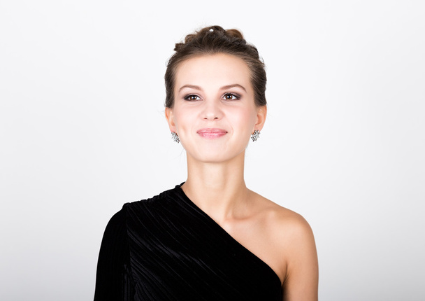 close-up fashion photo of young lady in elegant black dress, playful woman smiling - Foto, afbeelding