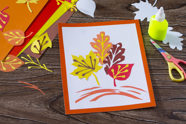 Jesienne liście kolorowego papieru na tle drewnianych. Arkuszy - Zdjęcie, obraz