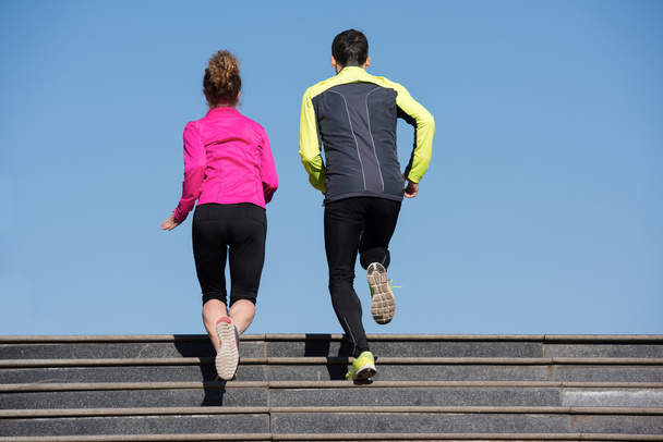young  couple jogging on steps - 写真・画像