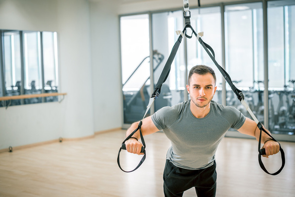 Suspension straps training in modern fitness facility - Photo, Image