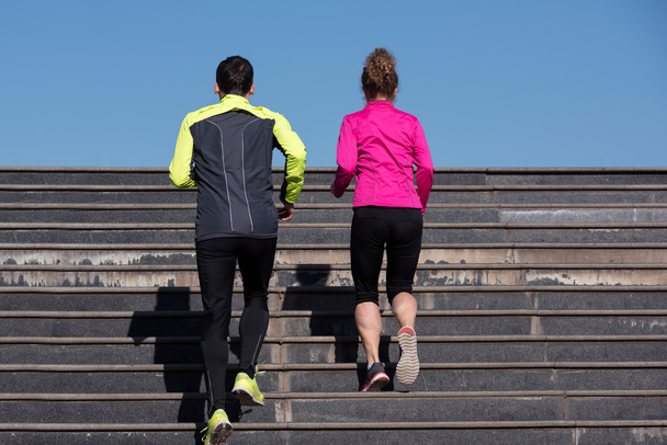 young  couple jogging on steps - Valokuva, kuva