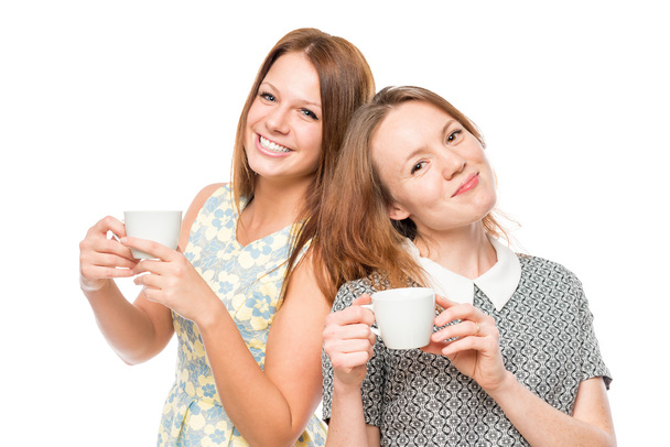 Horizontal portrait of two women with cups of coffee on a white  - Photo, Image