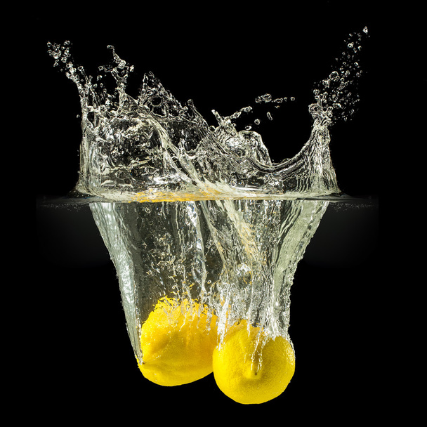 Group of fresh fruits falling in water with splash on black background - Photo, Image
