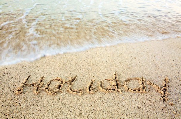 Vacaciones escritas en arena en la playa
. - Foto, Imagen