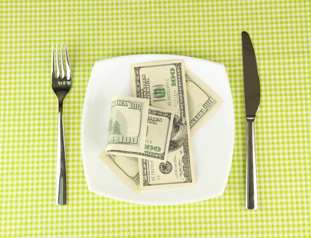Banknotes on the plate on green tablecloth close-up - 写真・画像