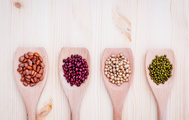 Assortment of beans and lentils in wooden spoon on wooden backgr - Photo, Image