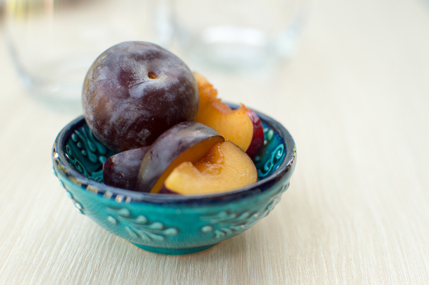 Ripe plums on a blue plate - Photo, Image