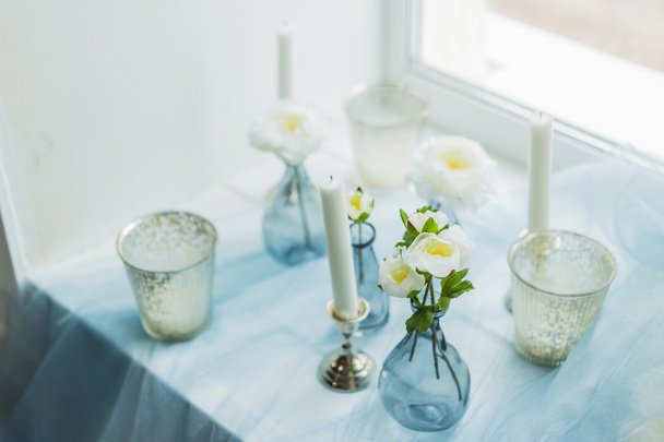 Decor of photostudio - white candles, blue textile - Φωτογραφία, εικόνα