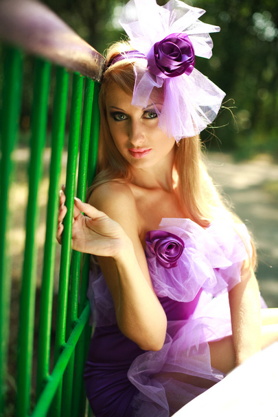 Close-up portrait glamorous young blonde girl,posing in violet dress - Photo, image