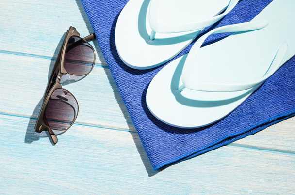stylish sunglasses with flip flops and towel - 写真・画像