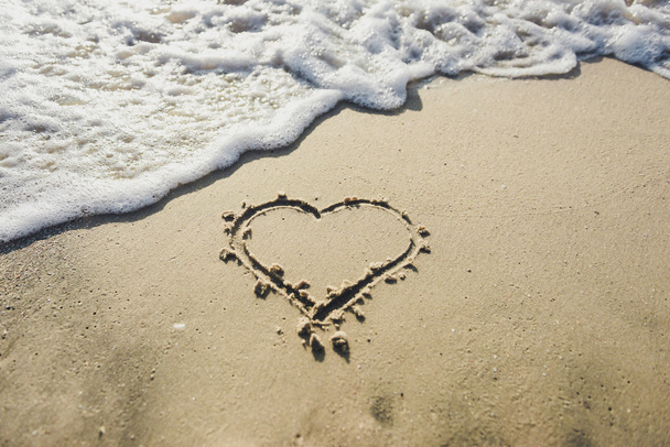 Heart on the sand beach. Conceptual love - Photo, Image