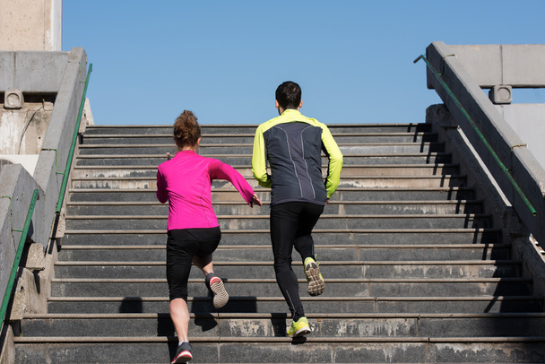 young  couple jogging on steps - Valokuva, kuva