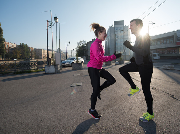 couple warming up before jogging - Foto, Bild
