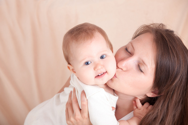 a young woman hugs her child - Valokuva, kuva