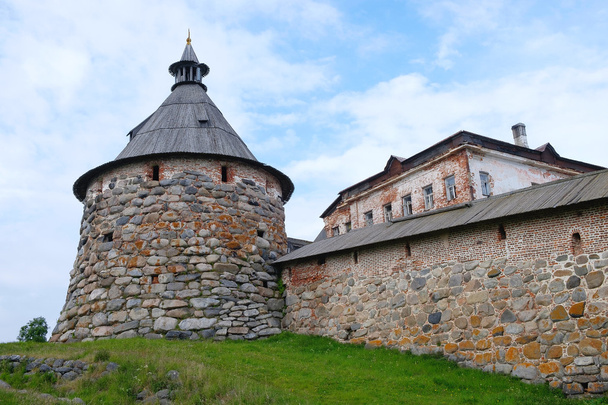 Ancient monastery tower and fragment of wall - Φωτογραφία, εικόνα