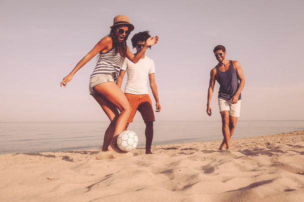 best friends playing beach football - Foto, afbeelding