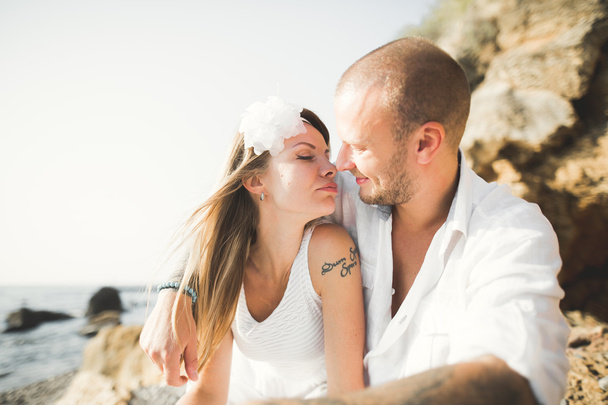 Fashion model couple with tattoo posing outside nea sea - Фото, изображение