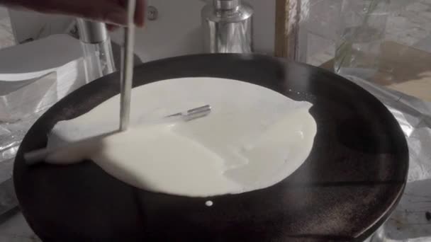 Dough on crepes / pancake maker being spread by T-shaped stick. SLOG3, medium shot. - Footage, Video