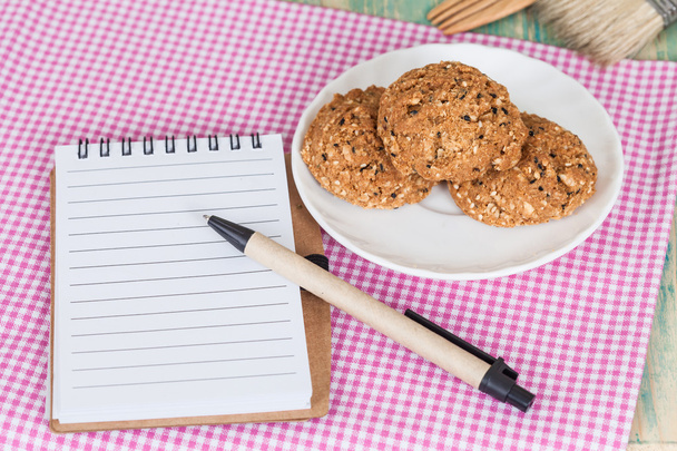 whole Grain cookie with note book On Wood table - Fotó, kép
