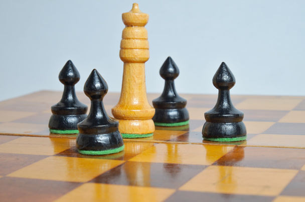 King surrounded by pawns on a white background - Photo, Image