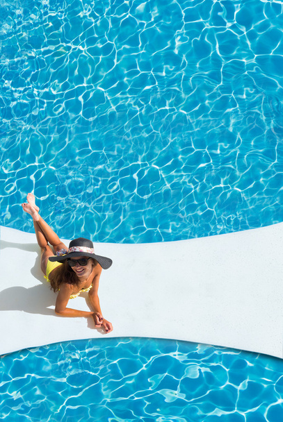 beautiful tanned sporty slim woman relaxing in swimming pool  - Fotoğraf, Görsel