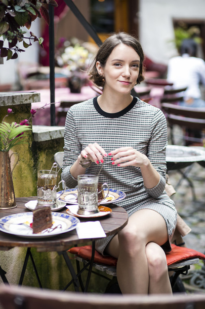 Woman at dress at street cafe drink tea - Photo, image