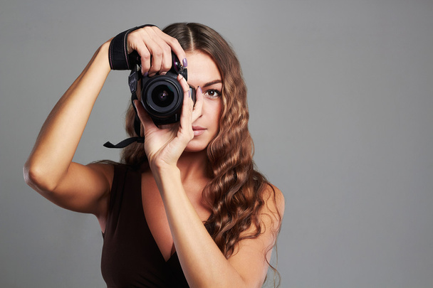 beautiful girl with camera.Pretty woman is a professional photographer - Photo, Image