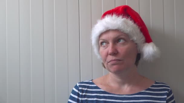 Disappointed woman with Christmas Santa Claus hat suffering from depression - Footage, Video