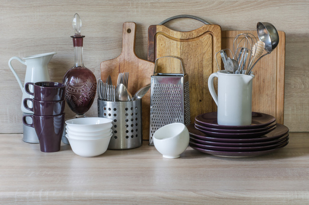 Crockery, tableware, utensils and other different stuff on wooden table-top.Kitchen still life as background for design.   - Photo, Image